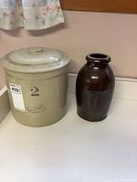 Both crocks side by side showing overall condition and size comparison