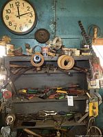 Overall shelves with wall clock and visible hand tools