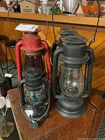 Group of four lanterns on wooden surface