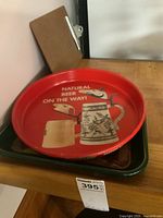 Red Utica Club round tray stacked on green tray