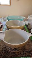 All three Pyrex bowls lined together showcasing color and patterns