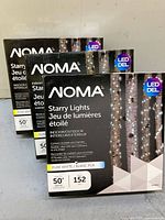 Front of three Noma Starry Lights boxes showing branding and specifications