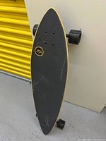 Grip-side view of Capix longboard standing upright