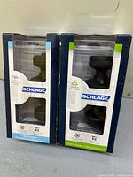 Front view of both boxed Schlage knob sets