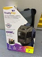 Front of retail box displaying TrustyPup 2-in-1 pet backpack & carrier, medium size and capacity details