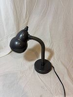 Lamp front view showing base, gooseneck, shade, power cord