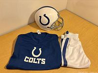 Helmet, jersey, and pants laid out on table