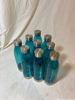 Nine teal Mainstays water bottles grouped together