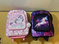 Front view of both backpacks showing designs and sizes