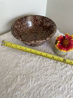 Top view showing mottled glaze pattern and diameter tape measure