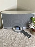 Front view of Bose SoundDock with iPod Nano docked and remote