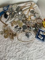 Full view of mixed jewelry spread on surface