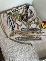 Overall view of necklaces and bracelets on white surface