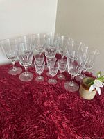 Group view of all crystal glasses on red surface