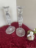 Full view of both etched crystal candlesticks upright on surface
