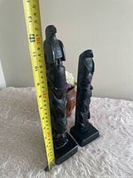 Both totem poles with tape measure showing 13 in height of taller piece