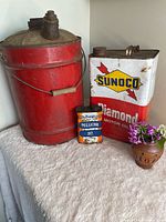 Overall view of three vintage oil cans
