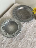 Both ashtrays showing size difference and rim engravings