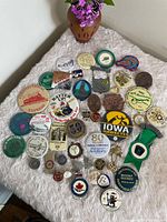 Overhead view of entire assortment of buttons and pins on fabric surface