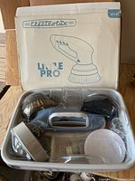 Overall kit in open box showing scrubber and heads