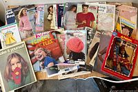 Overview of all knitting and crochet books and leaflets spread on table