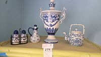 Front view of all blue and white ceramic items on shelf