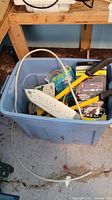 Overview of blue tote showing surge protector, extension cord, bolt cutters and packaged accessories