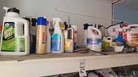 Shelf showing full assortment of cleaners, bug sprays, bleach and caulk