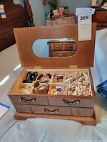 open jewelry box showing compartments and jewelry contents