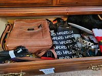 Drawer with tan crossbody purse, Madrid tote, belt, scarf and other accessories
