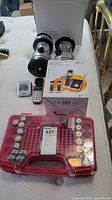 Lot overview showing two lanterns, boxed phone system, two loose handsets, Battery Daddy case