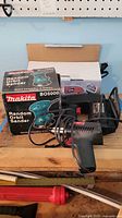 Makita BO5000 sander box, sander, jigsaw on workbench