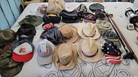 Overview of all hats, toiletry bags, cane and juggling balls on mattress