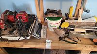Workbench view with tile saw, hand tools and bucket