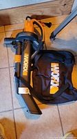Full view of Worx blower vacuum with bag on tiled floor