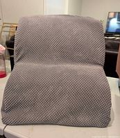 Front view of gray two-step foam pet stairs with textured cover