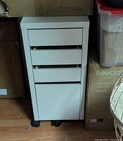 Front view of white 4-drawer Micke cabinet on casters