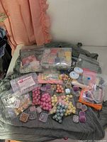 Entire lot spread out on fabric, showing storage case, bags, spools and small boxes