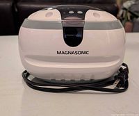 Front view of Magnasonic ultrasonic cleaner showing brand logo and power cord