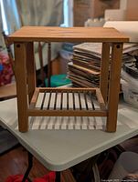 Full view of table showing top, legs and slatted shelf