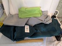 All three fabric pieces folded with measurement ruler for scale