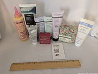 Group shot of all ten sealed personal-care items with ruler for scale