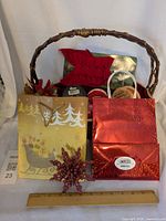 Overall lot view showing basket, gift bags, bow, ornament, ribbons