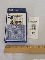 Front of jumbo playing card box beside ruler for scale