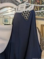 Close-up of neckline showing jeweled embellishment and white trim