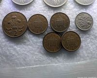 Close-up of 2p, three 1p coins and 1956 sixpence