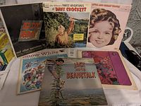 Group shot of all six vintage children’s record sleeves spread on table