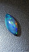 Marquise cabochon Ethiopian black opal showing blue, green and orange flashes