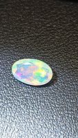 Top view of oval faceted Ethiopian opal showing multicolor play.