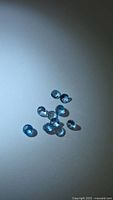 All nine round blue gemstones grouped on white background